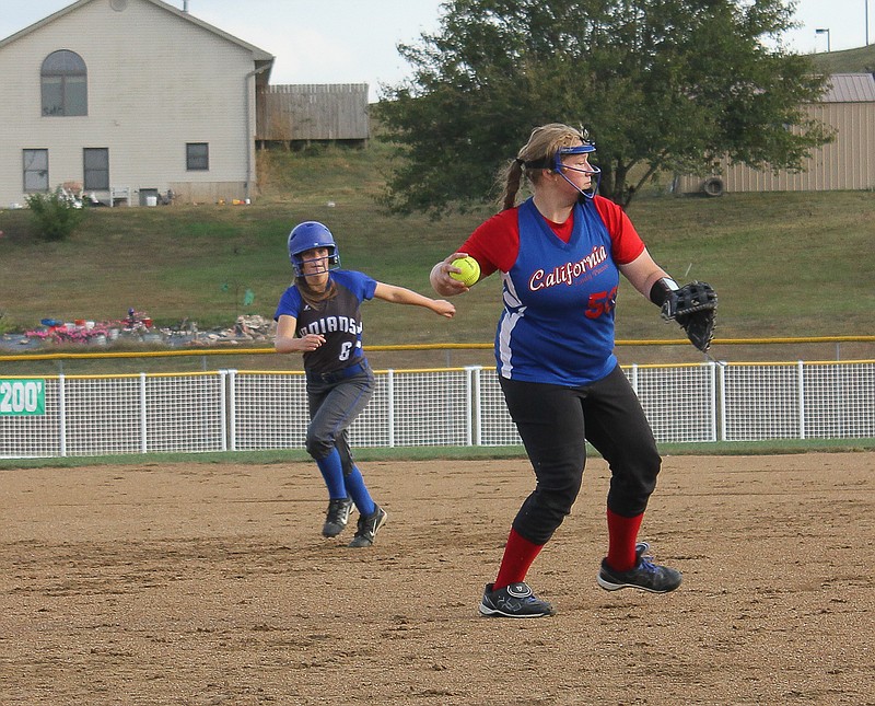 Third baseman Ashlyn Moore fields a ground ball and throws it to first during the Lady Indians' district game against Russellville.