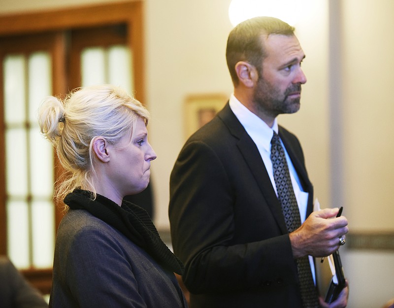 Ann Metternich, standing with her attorney Daniel Hunt, listens as Judge Dan Green finds her guilty of stealing.