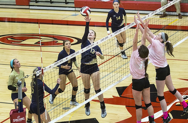 Helias' Suzie Kuensting tips the ball over the net Thursday in the Lady Crusaders' matchup against Jefferson City at Fleming Field House. 