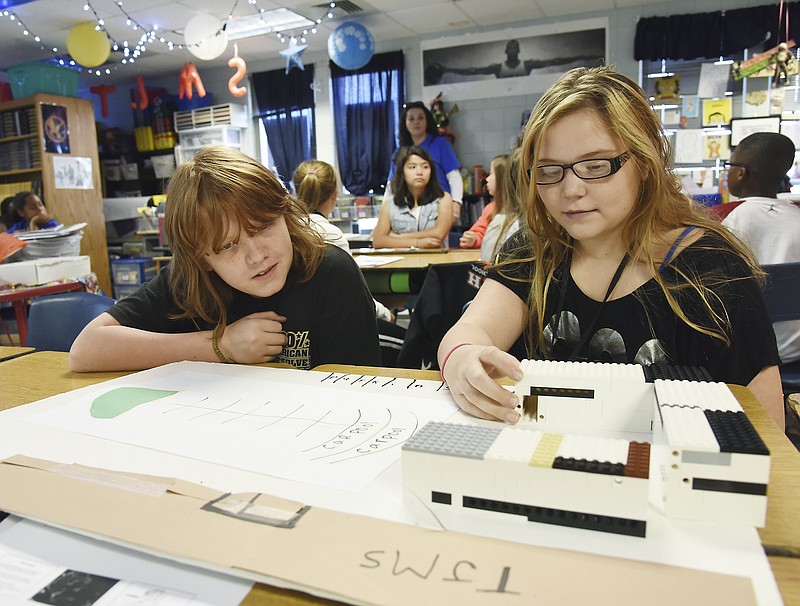 Jeremiah Heidbrink, left, and Hailey Boss arrange the Lego trailers their team built as space solutions. Both are students in Jeni DeFeo's sixth-grade contemporary issues class at Thomas Jefferson Middle School who saw need for increased space and, working with other teams in the class, devised a plan, which they presented to the Jefferson City Public School district superintendent Larry Linthacum.