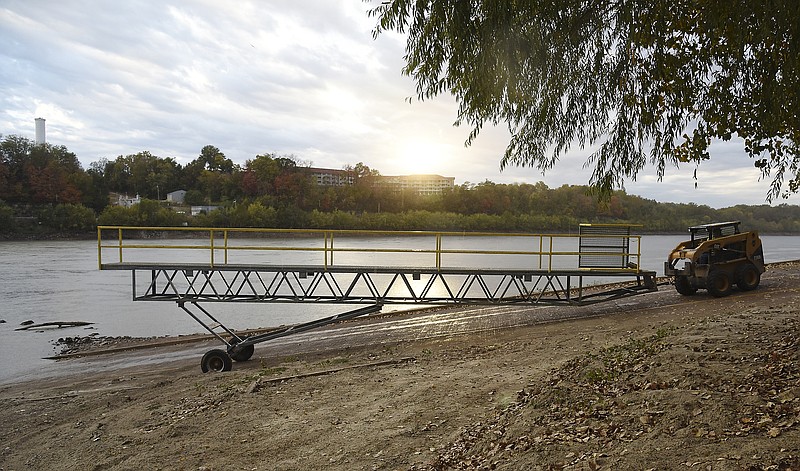 The ramp used to load and unload passengers to and from the river barge is pulled away from the bank of the Missouri River after a cruise was called off by the Coast Guard.