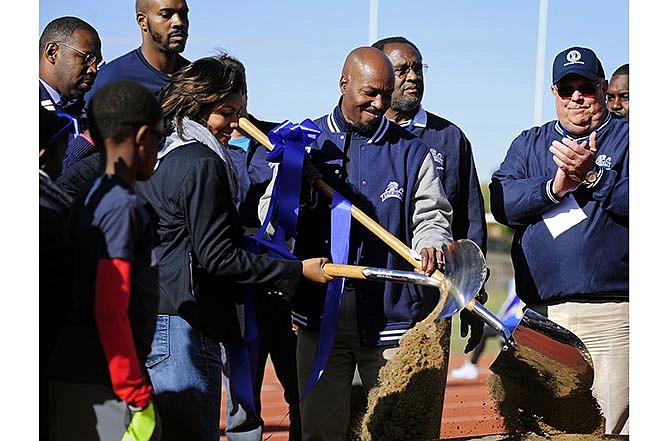 Lincoln University President Kevin Rome, center, and
Denise Chapel, center left, president of the Jefferson City
Parks and Recreation Commission, and a number of city,
university and Boys & Girls Club representatives participate
in a ceremonial groundbreaking Saturday for the
multipurpose/wellness center during halftime of Lincoln's
homecoming football game.