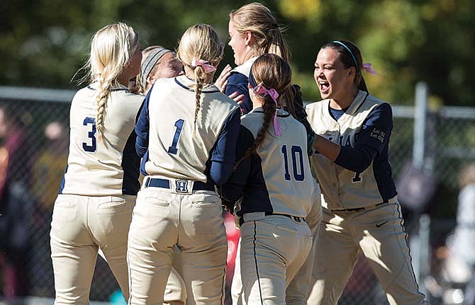 
Julie Harris is surrounded by her Helias teammates after making a diving catch in center field to end Saturday's 18-7 win against Logan-Rogersville at Duensing Field.