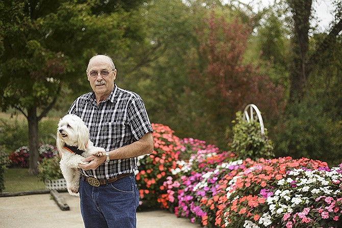 Sam Brizendine stands with Krackers the dog in his garden on Tanner Bridge Road. Sam and his wife Mary are five-time recipients of the Yard of the Month award. The Brizendines have lived at the home for nearly 50 years and been adjusting the garden ever since. Most recently, they've planted around 300 sunpatiens, which provide lots of color to the lot.