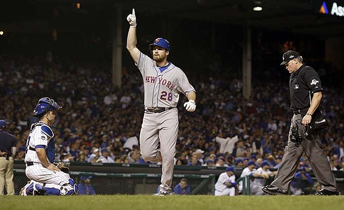 New York Mets' Daniel Murphy celebrates after hitting a home run during the third inning of Game 3 of the National League baseball championship series against the Chicago Cubs Tuesday, Oct. 20, 2015, in Chicago. 