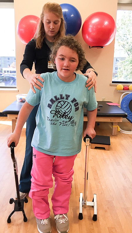 Russellville eight-year-old Maelyne Cartee received physical therapy from Rachel Drennan at the University of Missouri Children's Therapy Center in Columbia.