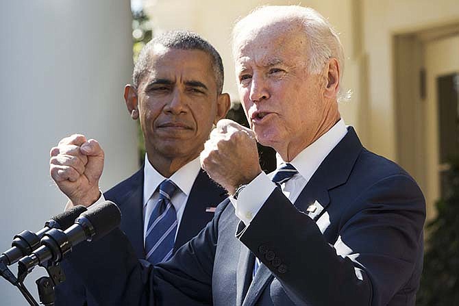 Vice President Joe Biden, with President Barack Obama, gestures as he speaks in the Rose Garden of the White House in Washington, Wednesday, Oct. 21, 2015, to announce that he will not run for the presidential nomination.