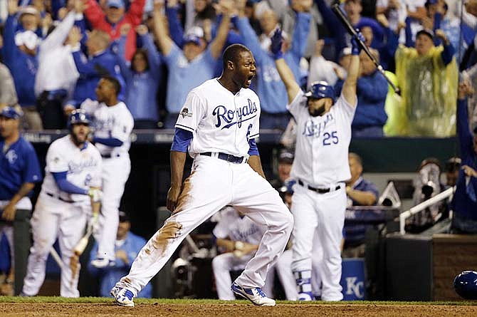 Kansas City Royals' Lorenzo Cain celebrates after scoring on a hit by Eric Hosmer against the Toronto Blue Jays during the eight inning in Game 6 of baseball's American League Championship Series on Friday, Oct. 23, 2015, in Kansas City, Mo. 