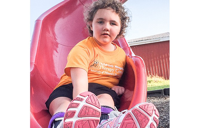 Maelyne Cartee enjoys the slide at the Russellville City Park.