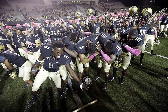 Vanderbilt players celebrate their 10-3 win over Missouri in an NCAA college football game Saturday, Oct. 24, 2015, in Nashville, Tenn.