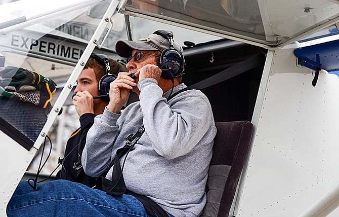
Light-sport pilot Dennis Sapp, front, and Young Eagle
flyer Austin Evers, 16, adjust their headsets before taking
flight in Sapp's Zenith CH701 airplane Saturday at the
Jefferson City Memorial Airport for the airport reopening
ceremony and fly-in event.