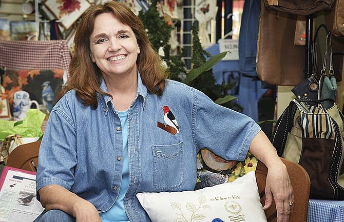 Regina Garr sits inside Birds-I-View, the store she owns with her husband, Steve Garr. For 14 years the store was strictly a catalog and web-based retailer, but they opened its Jefferson City retail location in 2005.