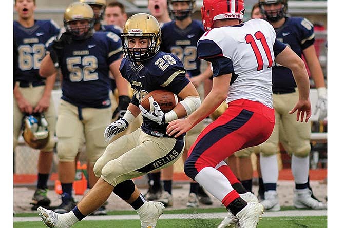 
Helias running back Dylan Gaines puts on the brakes as he tries to get past Wentzville Liberty's Branton McCain in Saturday's Class 4 District 7 game at Adkins Stadium.
