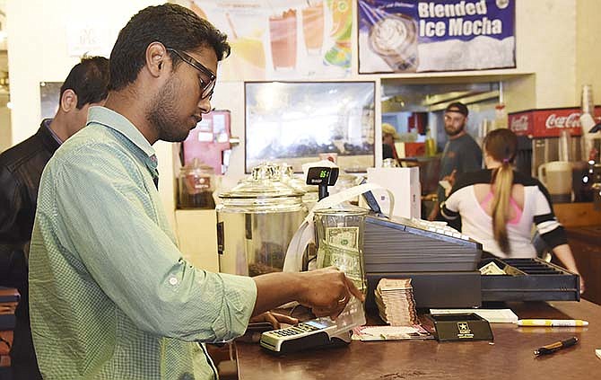 Chandra Kanth uses his credit card to pay for lunch at Coffee Zone, which uses a new EMV-enabled credit card reader.