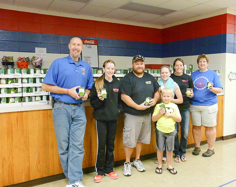 Worthey Bail Bonds donated over 700 cans of food to the California Middle School Food Drive, Thursday, Oct. 22. Standing in front of the huge donation, from left, CMS Principal Matt Abernathy, Brooklyn Bax, Landon Worthey, Dylan Ferguson, Shaylyn Bax, Joanie Luecke and CMS Counselor Marcia Bibb.