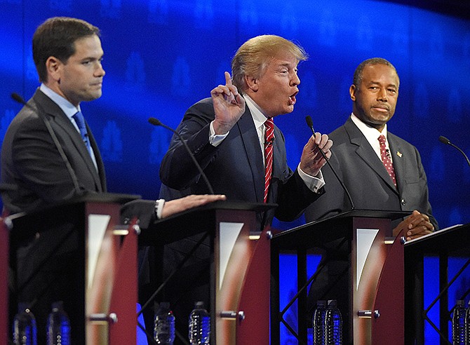 Donald Trump, center, makes a point as Marco Rubio, left, and Ben Carson look on during the CNBC Republican presidential debate Wednesday at the University of Colorado in Boulder.