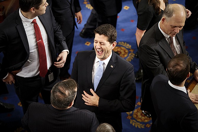 Just before taking his place as the new House Speaker, Rep. Paul Ryan, R-Wis., is congratulated by fellow members of Congress on Thursday in the House chamber on Capitol Hill in Washington. 