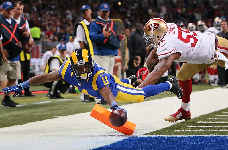 Rams wide receiver Tavon Austin gets past 49ers linebacker Ahmad Brooks to score a touchdown in Sunday's game in St. Louis.