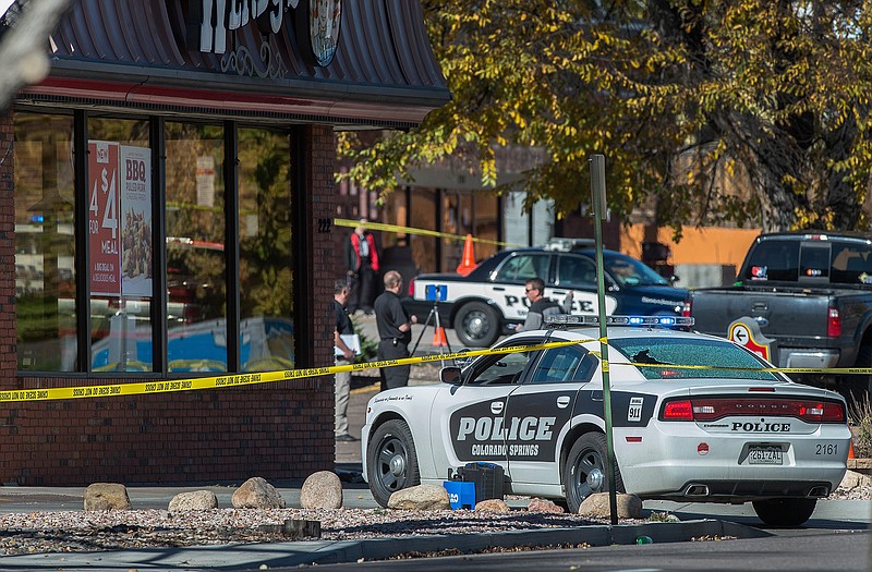 The rear window of a Colorado Springs Police car is shattered after a shooting Saturday, in Colorado Springs, Colo. Multiple are dead, including a suspected gunman, following a shooting spree according to authorities. 
