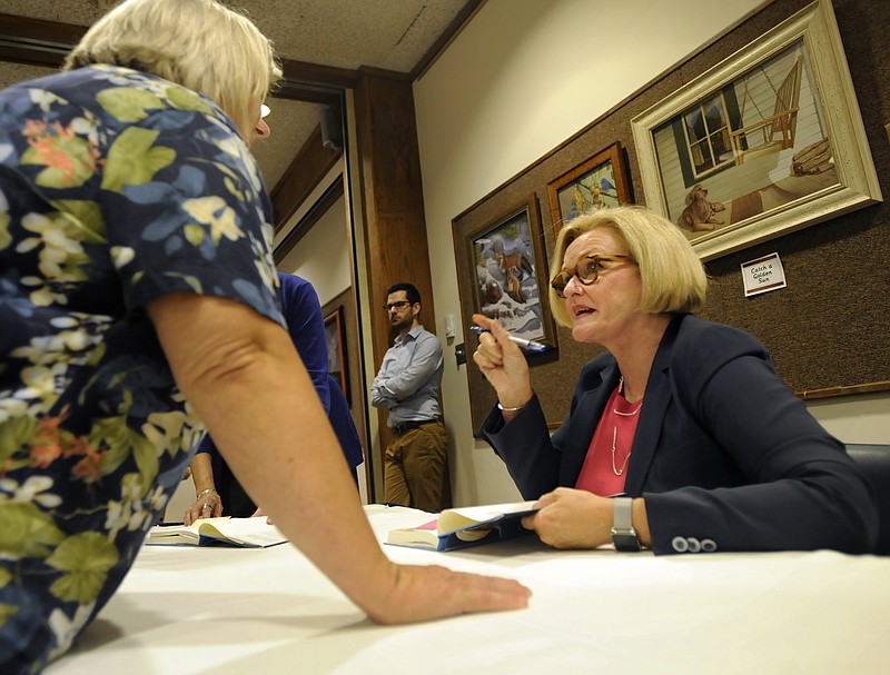 U.S. Sen. Claire McCaskill signs a copy of her memoir, "Plenty Ladylike," after speaking to the public at Missouri River Regional Library in August.