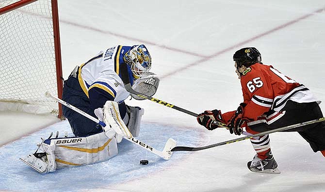 St. Louis Blues goalie Brian Elliot (1), makes a save against Chicago Blackhawks' Andrew Shaw (65), during the first period of a hockey game Wednesday, Nov. 4, 2015, in Chicago.