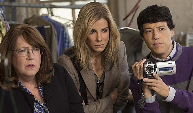 This photo provided by Warner Bros. Pictures shows, Ann Dowd, from left, as Nell, Sandra Bullock as Jane and Reynaldo Pacheco as Eddie, in Warner Bros. Pictures and Participant Media's satirical comedy "Our Brand Is Crisis," a Warner Bros. Pictures release. 