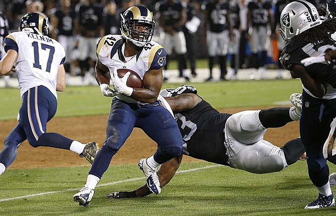 In this Aug. 14, 2015, file photo, St. Louis Rams running back Trey Watts (42) carries during the Rams' preseason football game against the Oakland Raiders in Oakland, Calif. Watts has been suspended indefinitely for violating the NFL's substance abuse policy. It's the second suspension this fall for Watts, who was out the first four games from a penalty handed down in late May.