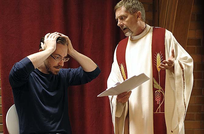 Jerico Whitaker, left, and Ken Thompson play the roles of Deacon Mark Dolson and Fr. Tim Farley during a rehearsal for the Capital City Players' upcoming production of "Mass Appeal" at Shikles Auditorium.