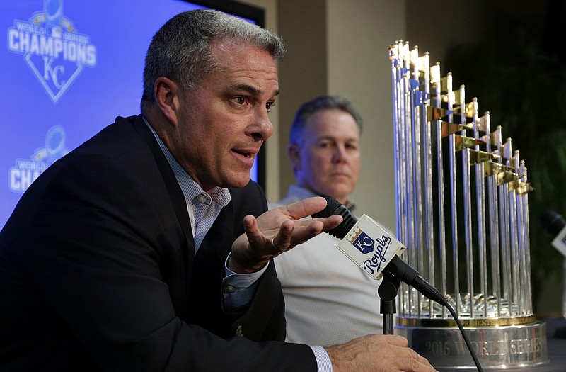 Royals general manager Dayton Moore (foreground) and manager Ned Yost sit near the World Series trophy while speaking to members of the media during their season wrapup news conference Thursday in Kansas City.