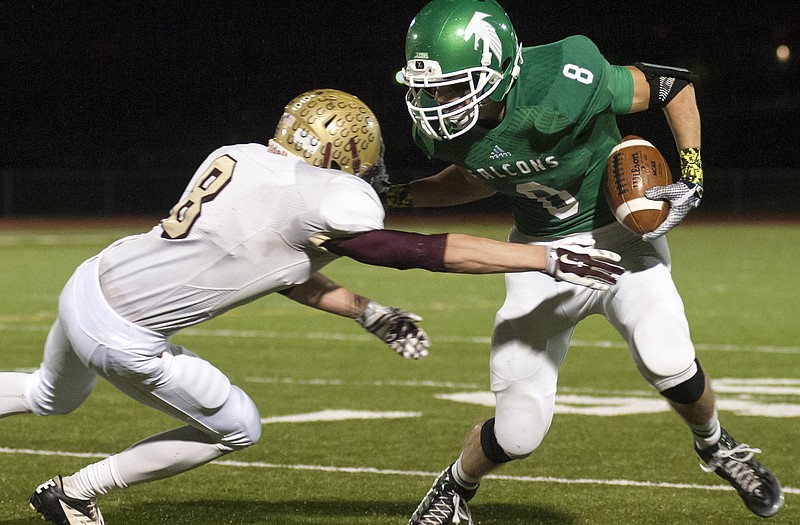 Blair Oaks wide receiver Adam Schell (8) stiff-arms Eldon cornerback Cole Hedrick after hauling in a pass near the sideline during last Friday's Class 3 District 6 semifinal game at the Falcon Athletic Complex in Wardsville. Schell slipped out of the grasp of another would-be tackler on his way to scoring a touchdown on the play.