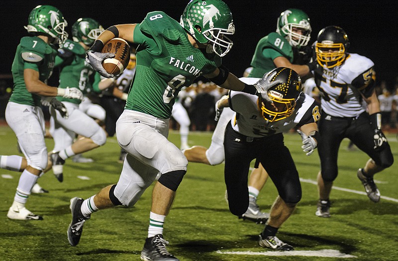 Blair Oaks safety Adam Schell stiff-arms Fulton's Alec Fleetwood as he returns an interception during Friday night's Class 3 District 6 championship game at the Falcon Athletic Complex in Wardsville.