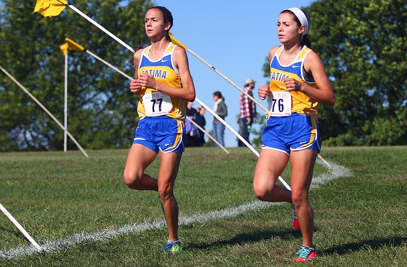 Fatima teammates Alyssa Strumph (left) and Katelyn Vanderfeltz look to help the Lady Comets to a Class 2 team state cross country title today at the Oak Hills Golf Center.