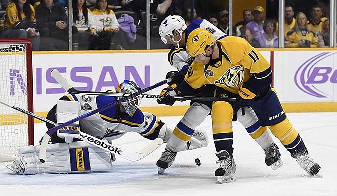 St. Louis Blues goalie Jake Allen (34) covers up the puck after a shot by Nashville Predators center Cody Hodgson (11) in the second period of an NHL hockey game, Saturday, Nov. 7, 2015, in Nashville, Tenn. Defending for Blues is Carl Gunnarsson (4), of Sweden.