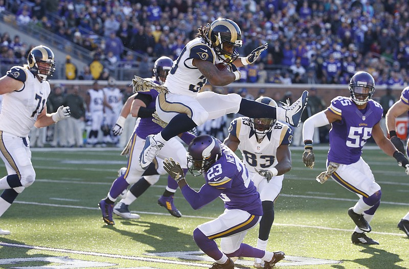 Rams running back Todd Gurley (30) leaps over Vikings cornerback Terence Newman (23) during the second half of Sunday's game in Minneapolis.