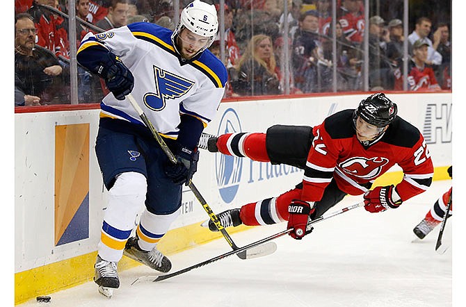 New Jersey Devils right wing Jordin Tootoo, right, falls to the ice as St. Louis Blues defenseman Joel Edmundson goes for the puck during the second period of an NHL hockey game, Tuesday, Nov. 10, 2015, in Newark, N.J. 