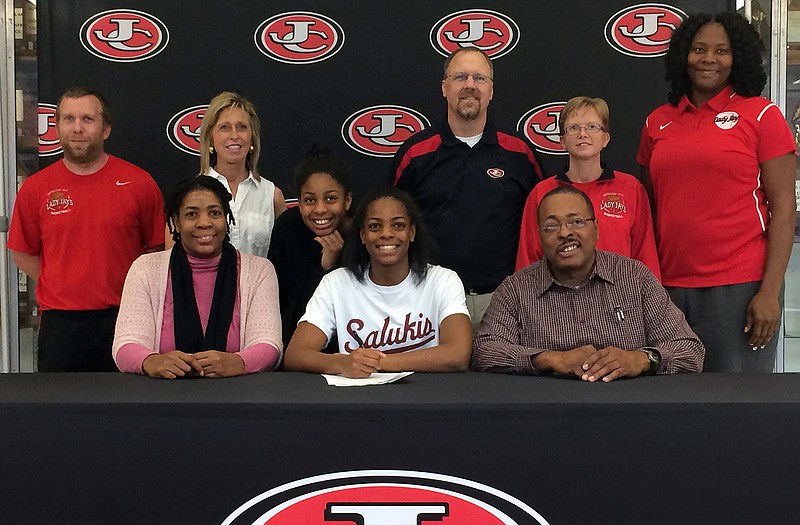 Nicole Martin of Jefferson City High School (seated center) signs a letter of intent Wednesday to play basketball at Southern Illinois University. Also seated are her parents, Pamela and Joe Martin, Standing (from left) are Lady Jays basketball coaches Ben Hays and Kay Foster, her sister Yolanda Martin, and Lady Jays coaches Brad Conway, Theresa Pistel and Elfreda Reid.