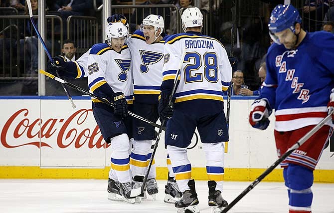 St. Louis Blues right wing Dmitrij Jaskin (23), center, celebrates with Blues left wing Magnus Paajarvi (56), of Sweden, and center Kyle Brodziak (28) after scoring a goal in the first period of an NHL hockey game against the New York Rangers in New York, Thursday, Nov. 12, 2015. 