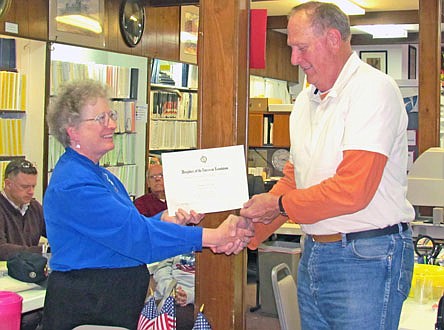 DAR Regent Nelta Cherry (left) presents a certificate to Wayne Bill.