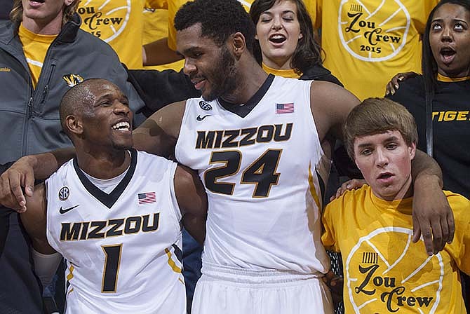 Missouri's Terrence Phillips (1) and Kevin Puryear (24) celebrate with Missouri fans in the crowd after Missouri defeated Wofford 83-74 in an NCAA college basketball game Friday, Nov. 13, 2015, in Columbia, Mo.