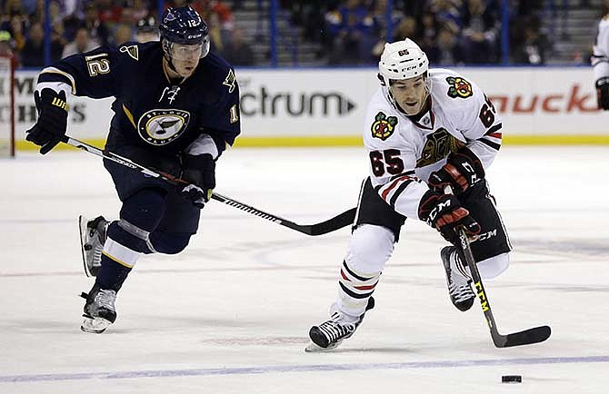 Chicago Blackhawks' Andrew Shaw, right, controls the puck as St. Louis Blues' Jori Lehtera, of Finland, gives chase during the third period of an NHL hockey game Saturday, Nov. 14, 2015, in St. Louis. The Blackhawks won 4-2. 
