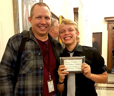 AJ Ballard (right) and his father, Jason Ballard, smile after the Fulton High School freshman was named winner of the Scout award for diligence in the pursuit of truth, justice and freedom.