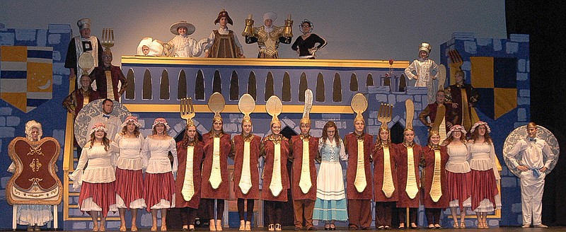 The castle staff, enchanted as household items, greet Belle, the peasant girl, and welcome her to the castle.