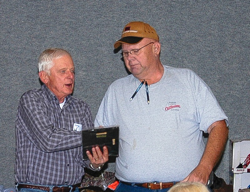 At the Moniteau County Cattlemen's Dinner and Auction, Charlie Stock is presented an "Outstanding Cattlemen's Award" plaque by David Gier. The award was presented in thanks for his many years of support to the association.