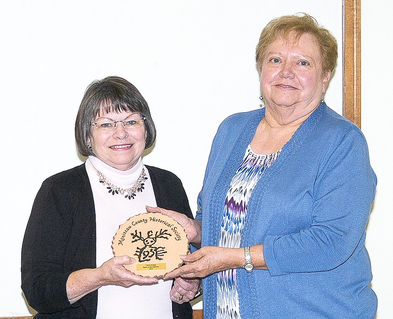 At the annual Moniteau County Historical Society dinner, Shirley Elliott, left, presents the Manitou Award to Gloria Knipp.