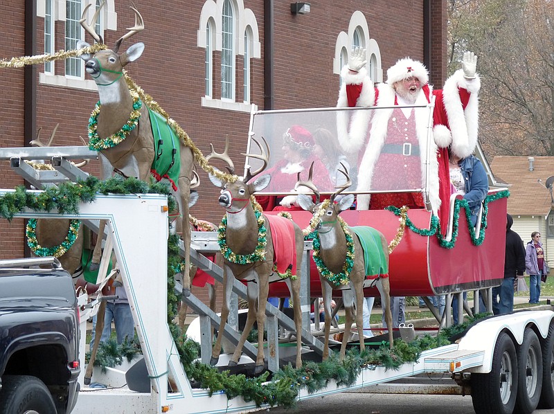 Santa waves to children and spectators at the 2014 Eldon Christmas Celebration Parade in Eldon.