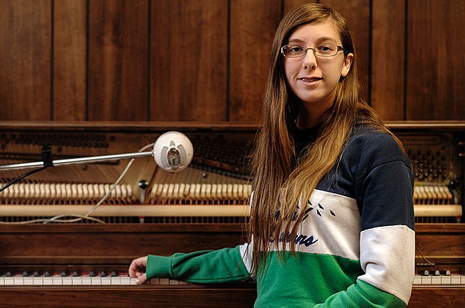 Local fiction author and songwriter/musician Hannah Hughes sits alongside the piano in her family's basement where she writes and records her own music. Hughes, a 15-year-old freshman at Blair Oaks High School in Wardsville, recently hosted a book signing at Hastings in Jefferson City following the release of her novel "Games."