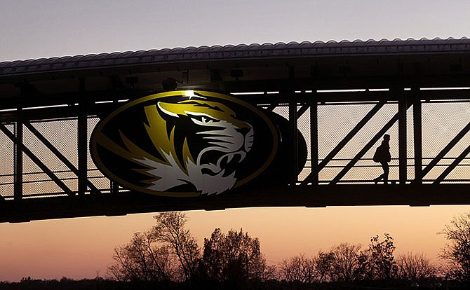 This photo taken Nov. 9, 2015, shows a University of Missouri student walking across the bridge over Providence Road in Columbia.
