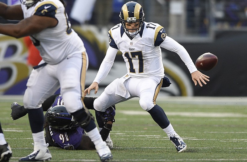 Rams quarterback Case Keenum (17) fumbles the ball after being hit by Ravens linebacker Courtney Upshaw during Sunday's game in Baltimore.