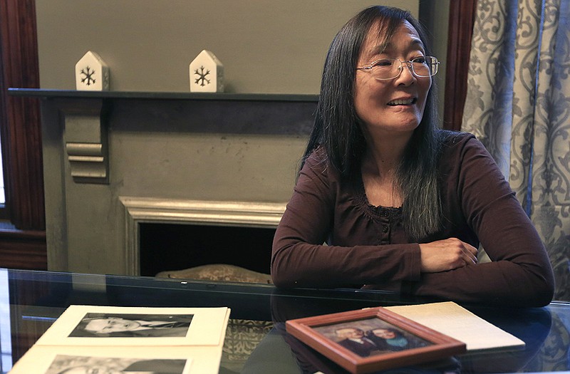 Laupie Yasui sits for an interview with photos of her father Minoru Yasui on a table in her daughters home in Kansas City. Laupie Yasui will receive the Presidential Medal of Freedom on behalf of her father this week.