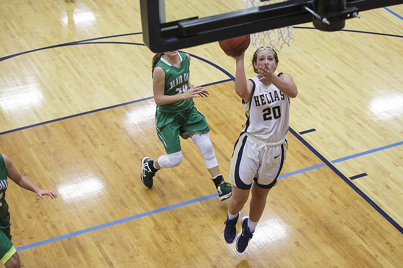 Helias' Olivia Johanns tosses up a basket off a fast break during Tuesday night's game against Blair Oaks at Rackers Fieldhouse.